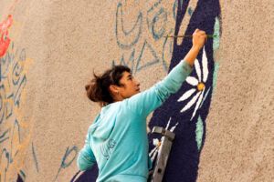 La artista Celia Hoyos trabajando en el mural de la calle la Fuente de Alcampell. Foto: María Mateo.